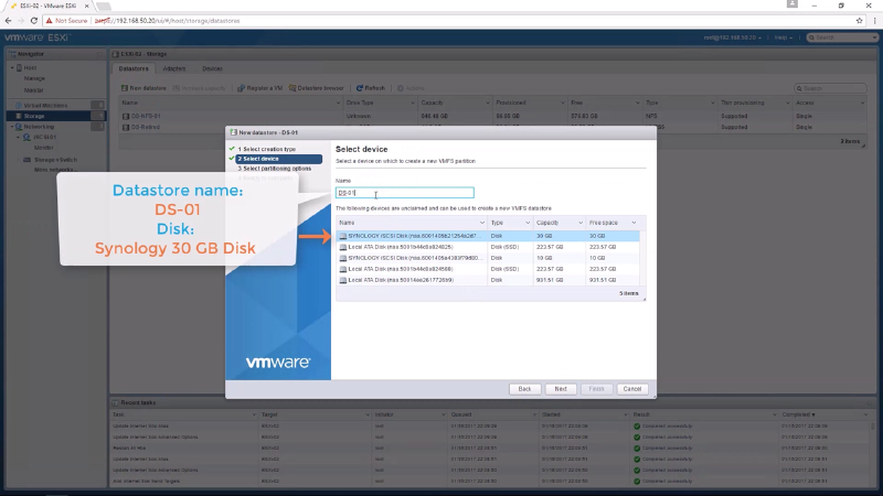 Screenshot of VMware ESXi interface showing the &ldquo;Select device&rdquo; window. A Synology 30 GB disk is highlighted for a new datastore named &ldquo;DS-01.&rdquo; The interface lists available disks with capacities and free space.